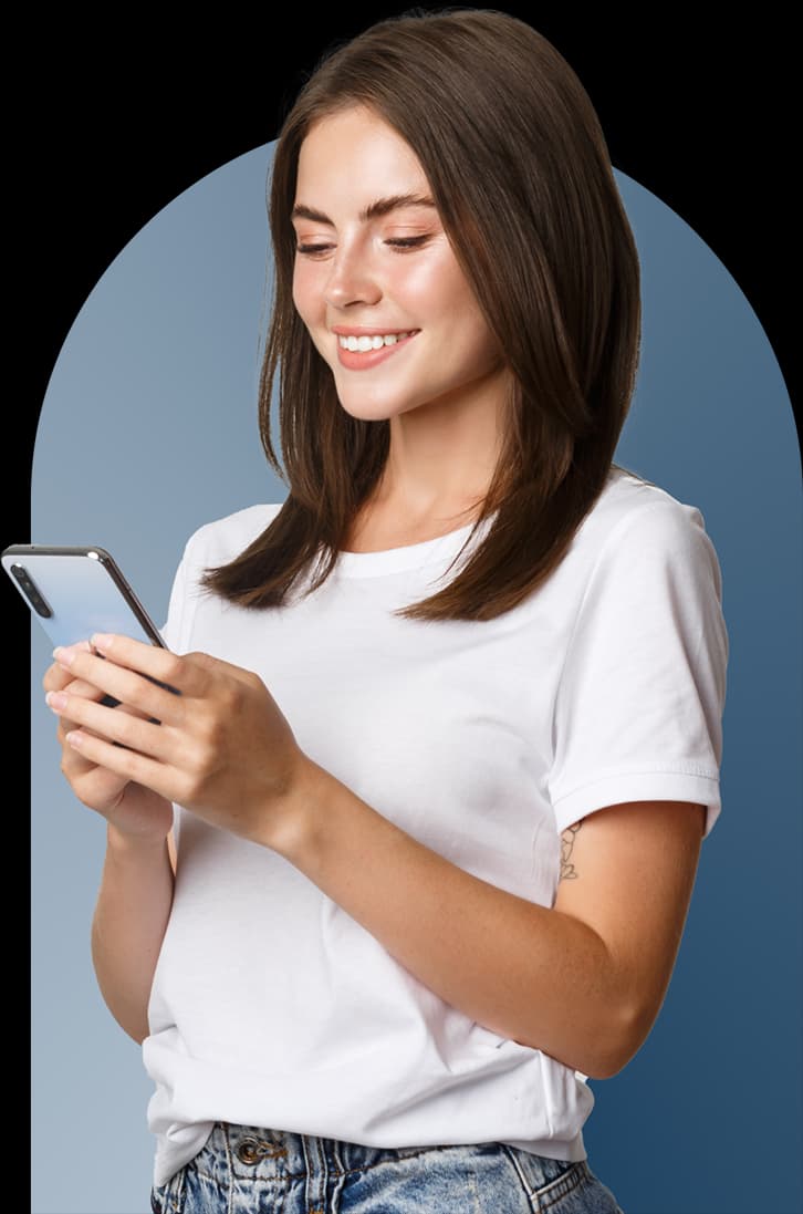 Person who can be described as female, happily looking at a smartphone
